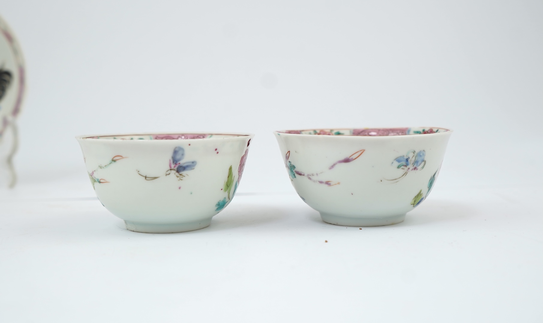 A near pair of Chinese famille rose ‘cockerel’ tea bowls and saucers, Yongzheng period